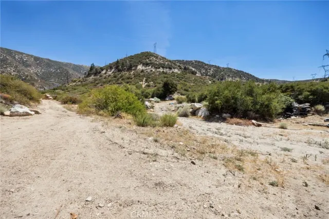 a view of a dry yard covered with snow in the background