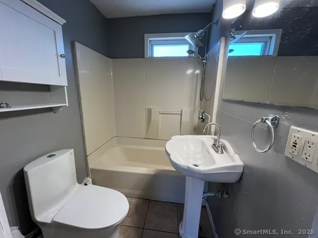 a bathroom with a sink toilet and a mirror