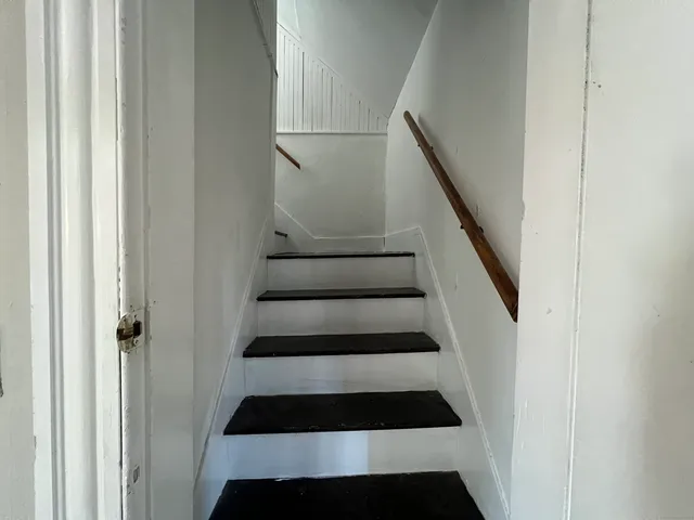 a view of staircase with white walls