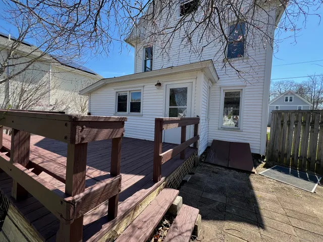 a view of a house with a wooden fence