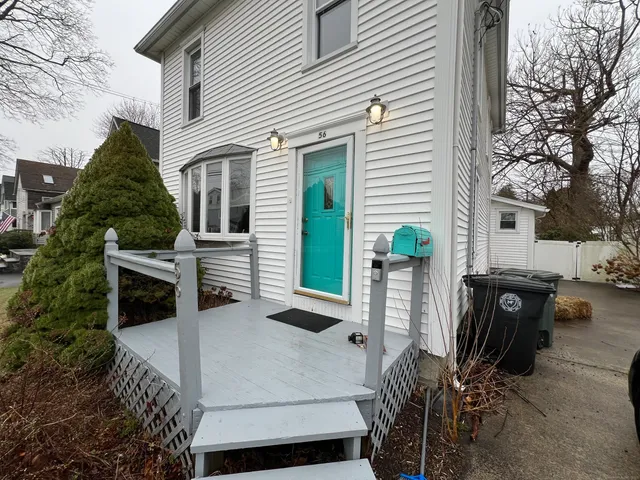 a view of a patio with a table and chairs and potted plants