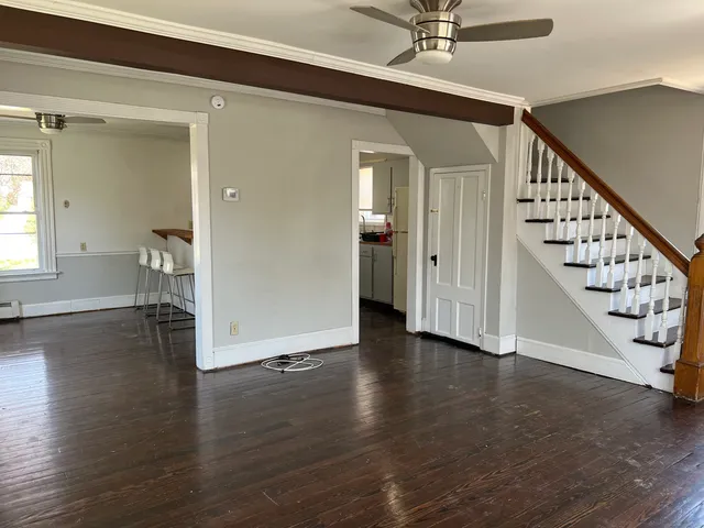 a view of an entryway with wooden floor and stairs