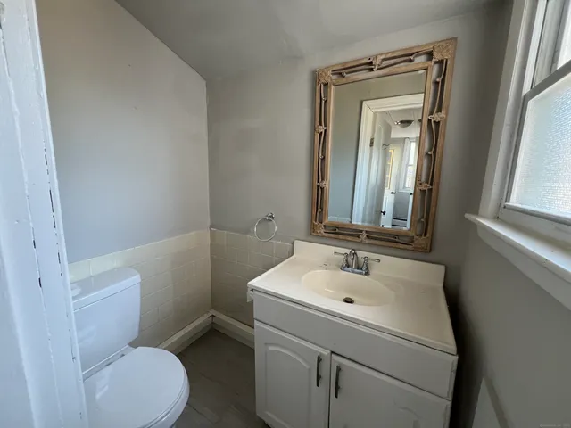 a bathroom with a sink toilet and mirror