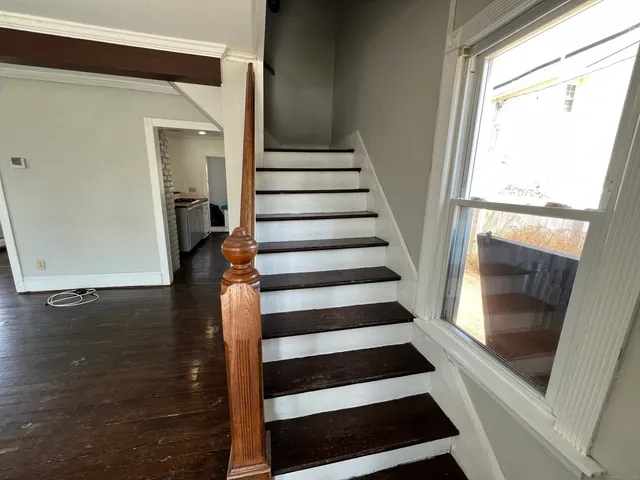 a view of entryway with wooden floor and door
