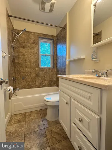 a bathroom with a sink a toilet and a bathtub