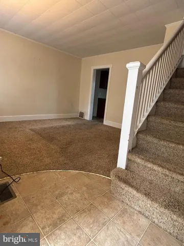 a view of an empty room with stairs