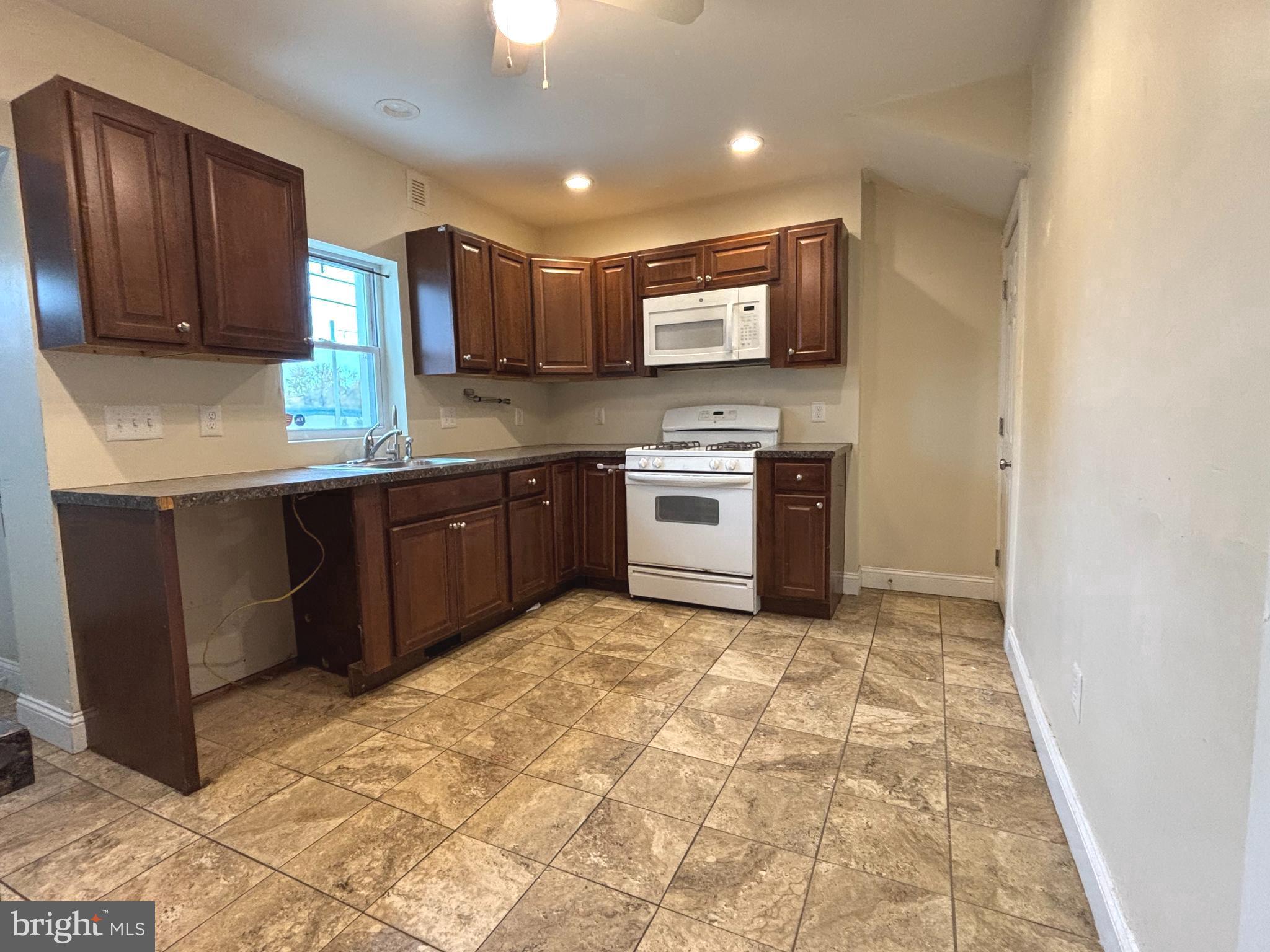 207 New Jersey Road Brooklawn, NJ 08030 - Photo 10 of 14 a kitchen with stainless steel appliances granite countertop a stove top oven sink and cabinets