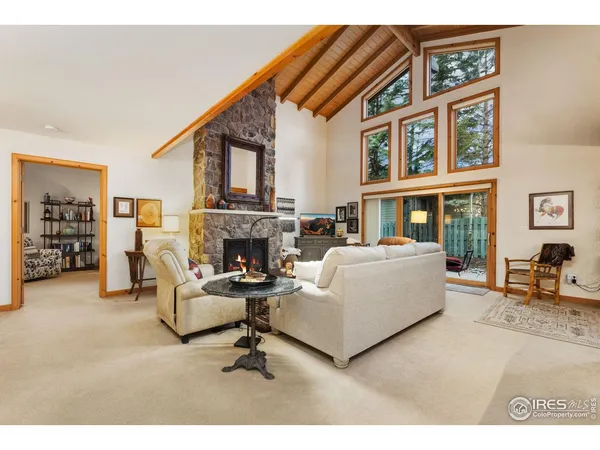 a living room with furniture a fireplace and a painting