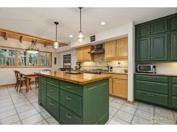 a kitchen with stainless steel appliances granite countertop a sink a stove and a refrigerator
