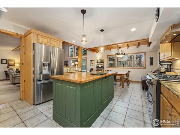 a kitchen with granite countertop a stove a sink dishwasher and cabinets