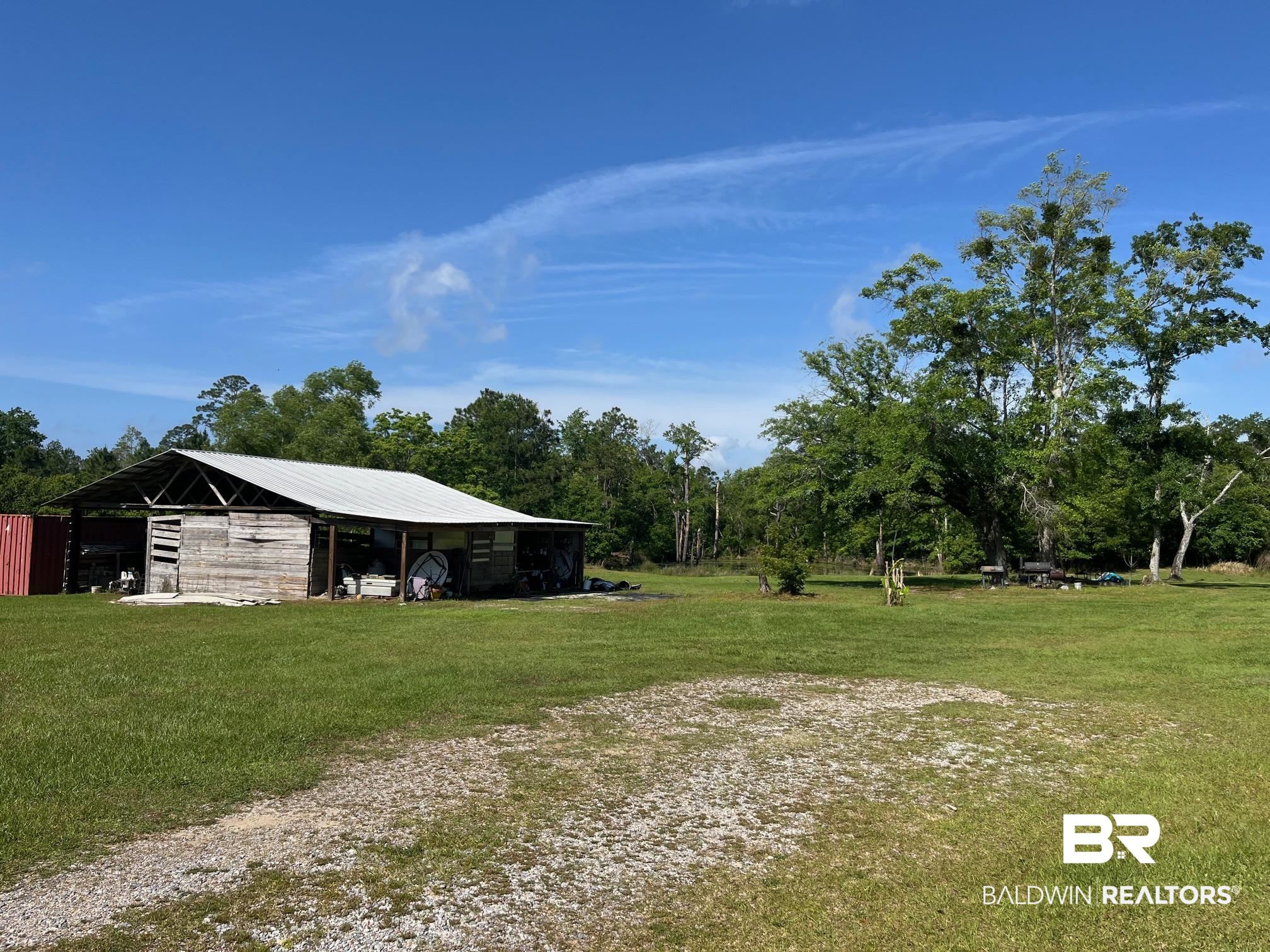 13827 County Road 83 Elberta, AL 36530 - Photo 2 of 38 View of yard featuring a detached carport, a pole building, and an outbuilding