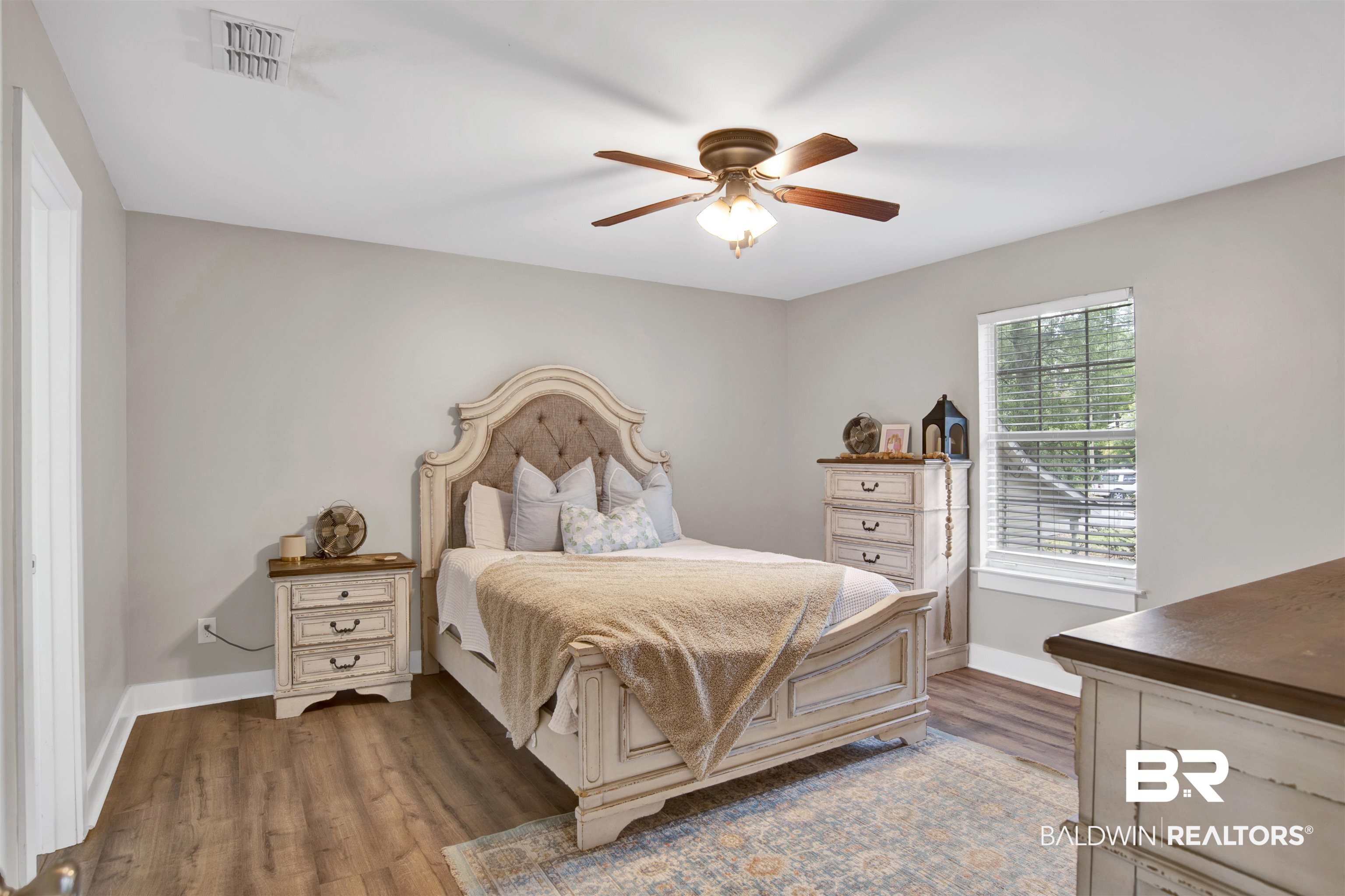 253 Maplewood Loop Daphne, AL 36526 - Photo 26 of 30 Interior room featuring wood-finish flooring, a ceiling fan with light fixture, and a window with blinds