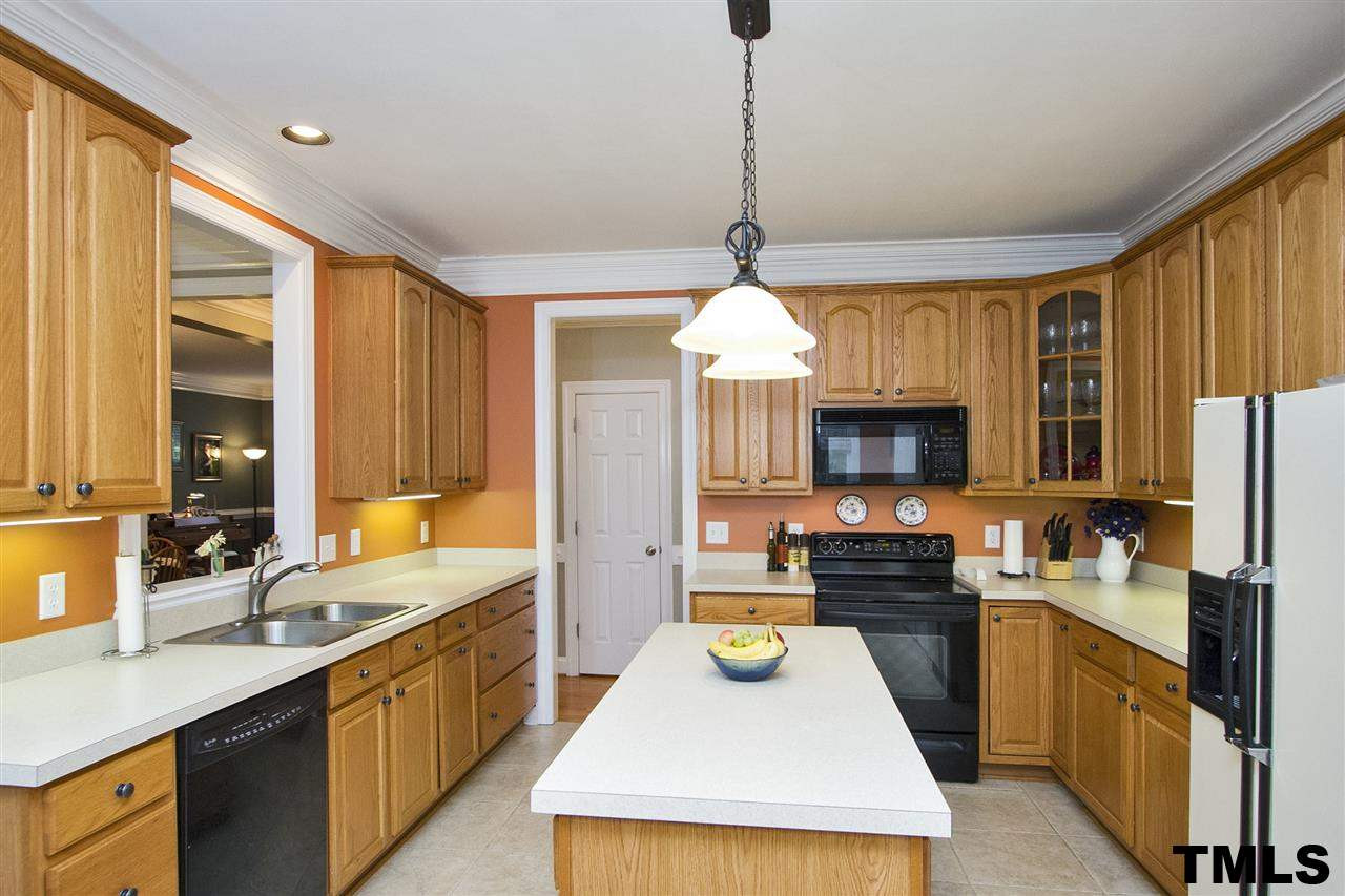 2012 Waterbrook Court Raleigh, NC 27603 - Photo 6 of 25 Kitchen with Island, Lots of Counter and Cabinet Space, Tile Floor, Large Pantry Kitchen