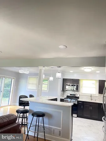 a kitchen with stainless steel appliances kitchen island granite countertop a sink and cabinets