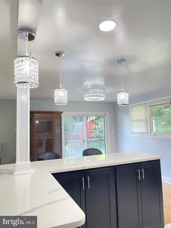 a kitchen with a sink and chandelier