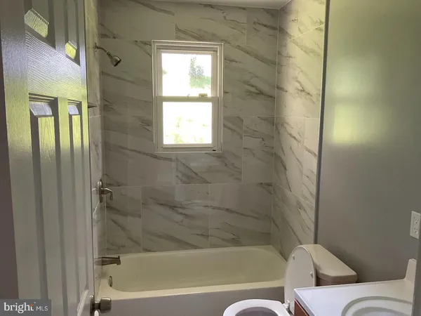 a bathroom with a bathtub and window