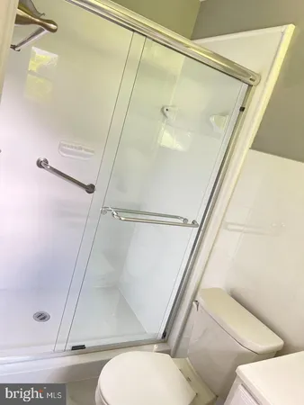 a bathroom with a toilet and a shower