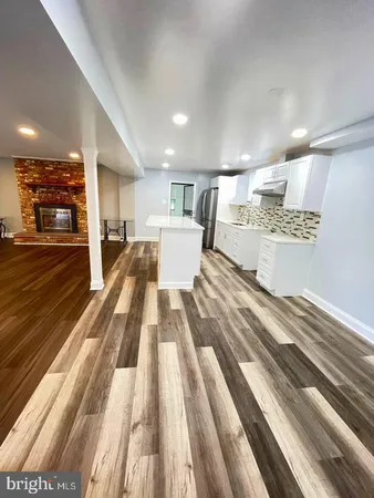 a view of a living room and kitchen with furniture