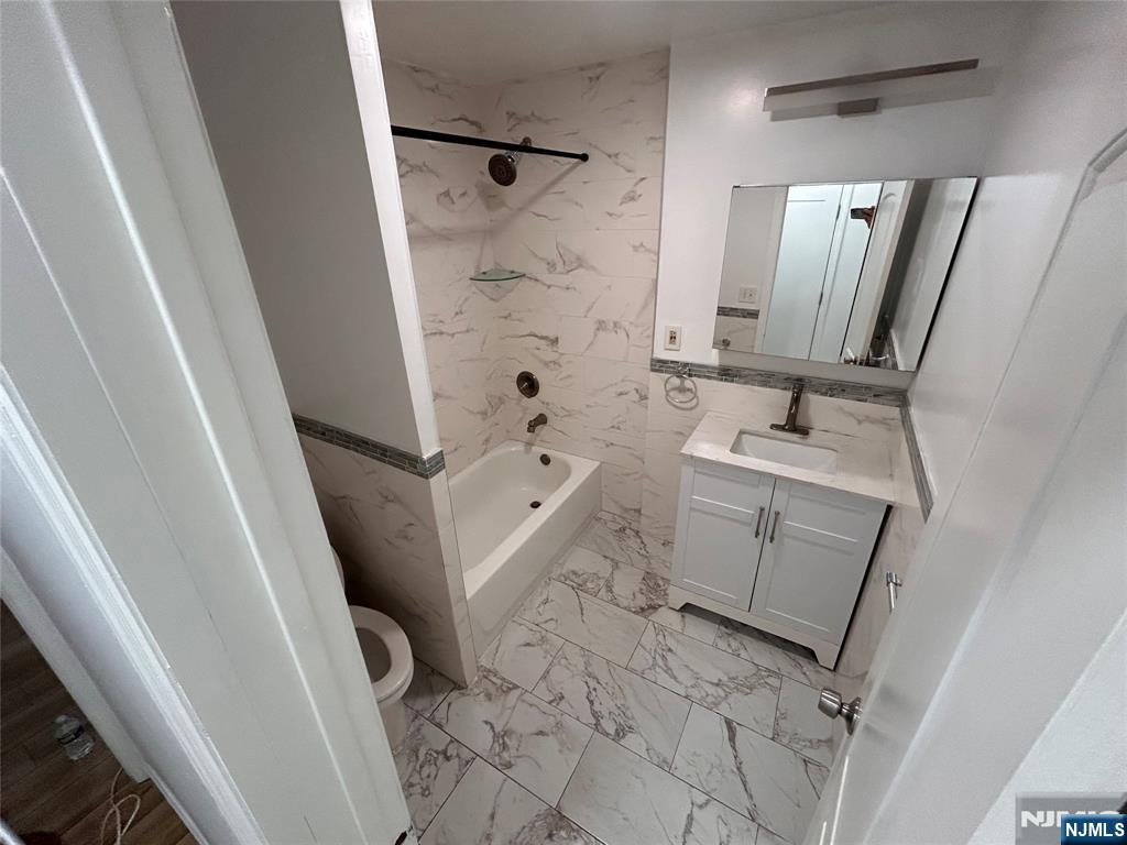 224 Fort Lee Road Bogota, NJ 07603 - Photo 11 of 12 a bathroom with sink toilet and shower