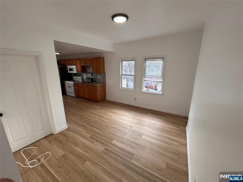 224 Fort Lee Road Bogota, NJ 07603 - Photo 4 of 12 wooden floor in an empty room with a window