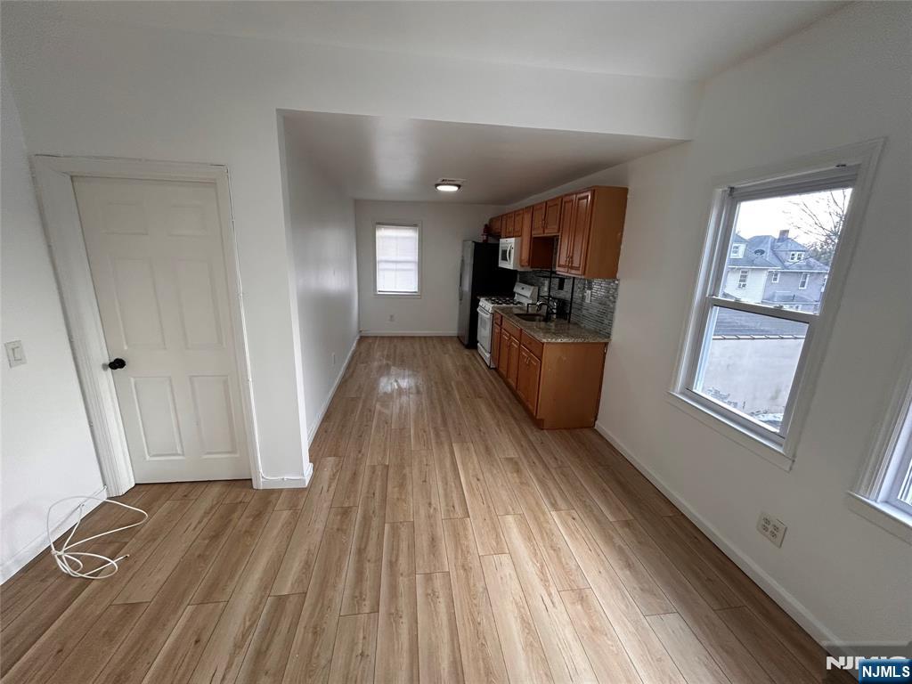 224 Fort Lee Road Bogota, NJ 07603 - Photo 5 of 12 a view of a living room hardwood floor and a kitchen