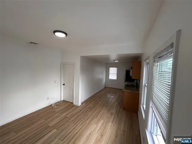 a view of a room with wooden floor and stairs