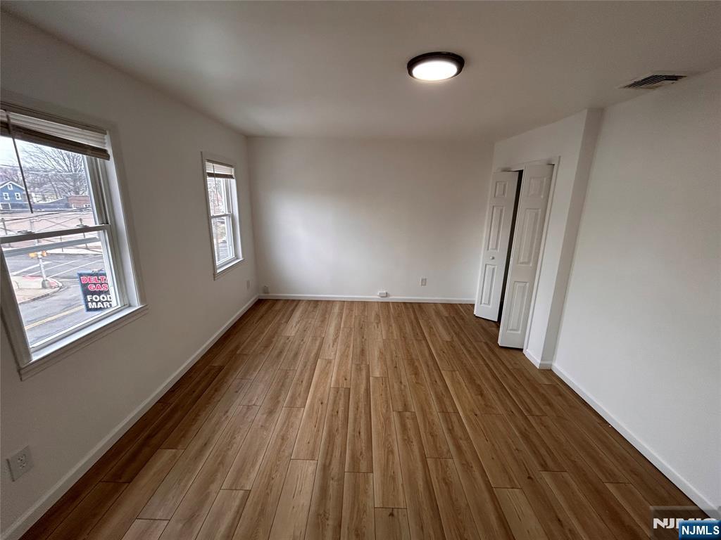 224 Fort Lee Road Bogota, NJ 07603 - Photo 8 of 12 wooden floor in an empty room with a window
