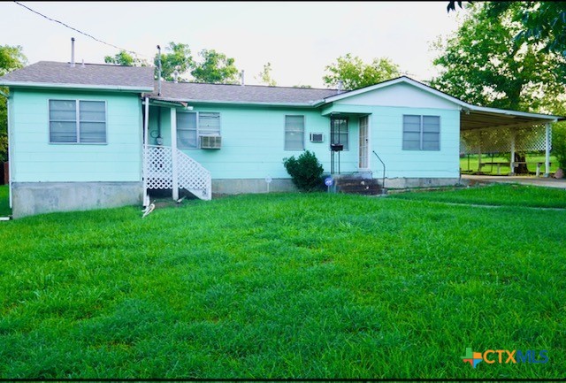 a front view of house with yard and green space