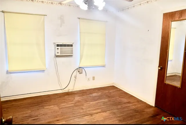 a view of hallway with wooden floor