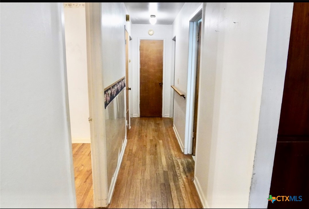 141 Jackson Street Elgin, TX 78621 - Photo 22 of 28 a view of hallway with wooden floor