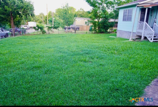 141 Jackson Street Elgin, TX 78621 - Photo 3 of 28 a front view of a house with garden