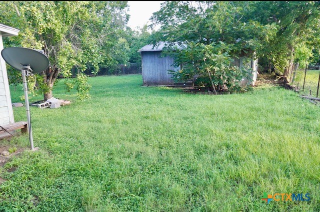 141 Jackson Street Elgin, TX 78621 - Photo 6 of 28 a view of a backyard with table and chairs and potted plants and large trees