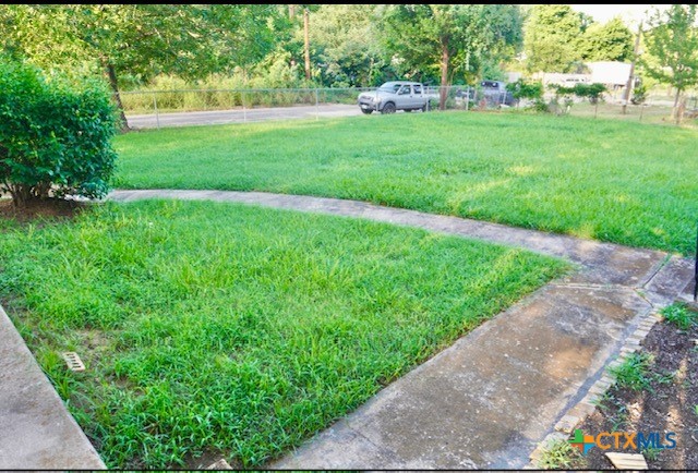 141 Jackson Street Elgin, TX 78621 - Photo 7 of 28 a view of a garden with a house