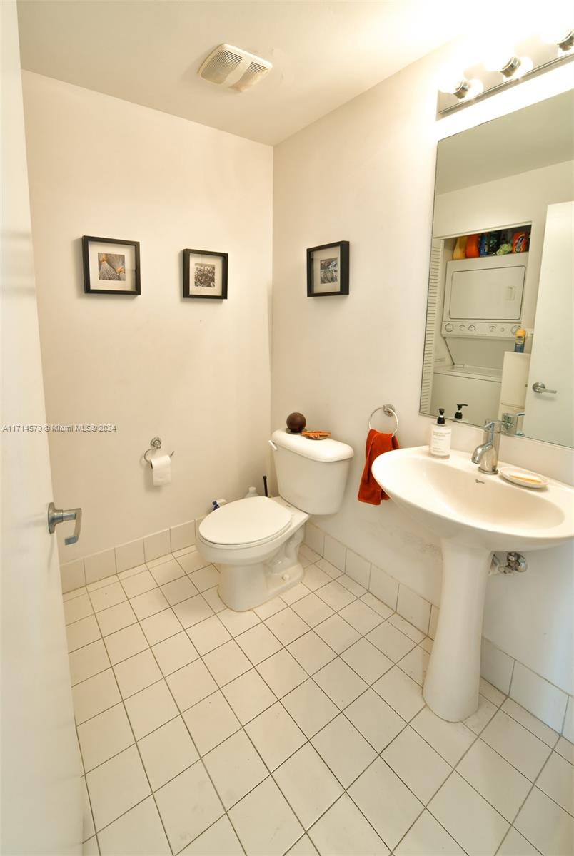 888 Biscayne Boulevard, Unit 2511 Miami, FL 33132 - Photo 11 of 26 a bathroom with a sink mirror and toilet