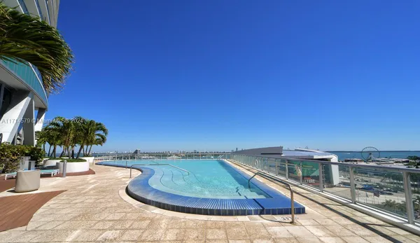 a view of a swimming pool with an outdoor seating and a potted plants