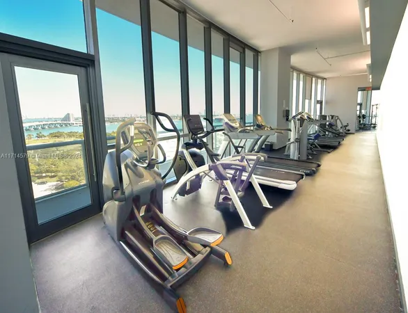 a room with gym equipment and a large window