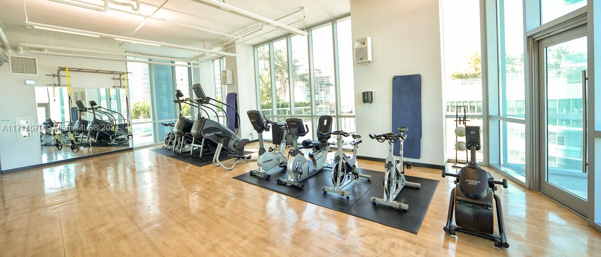 888 Biscayne Boulevard, Unit 2511 Miami, FL 33132 - Photo 19 of 26 a view of a room with gym equipment