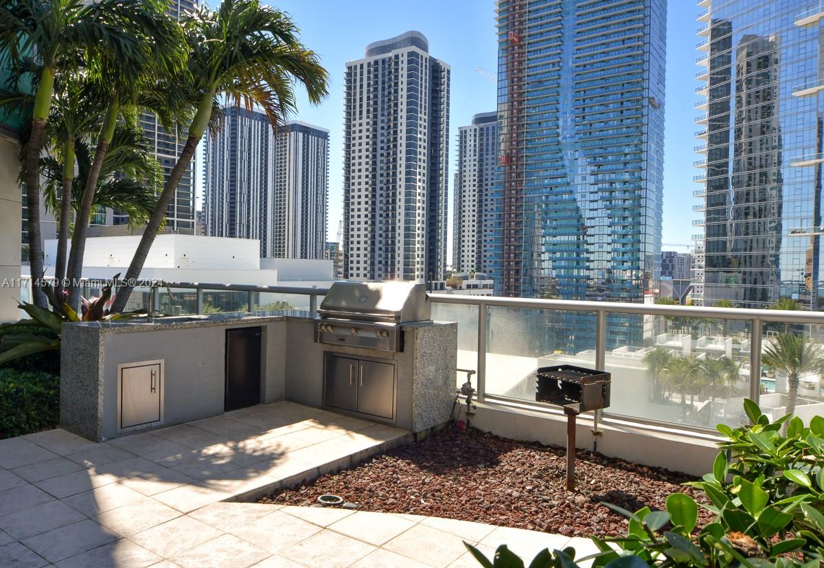 888 Biscayne Boulevard, Unit 2511 Miami, FL 33132 - Photo 20 of 26 a table and chairs in front of a building