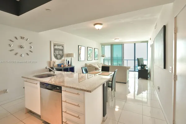 a view of a kitchen counter space and living room