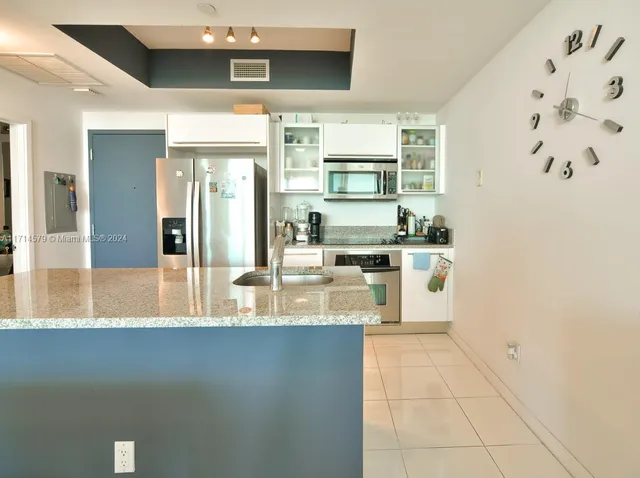 a kitchen with stainless steel appliances a stove and a refrigerator