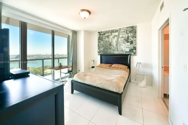 a bed sitting in a bedroom next to a window