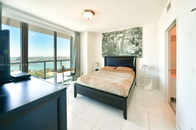 a bed sitting in a bedroom next to a window