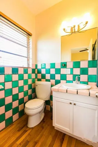 a bathroom with a sink a toilet and a shower curtain