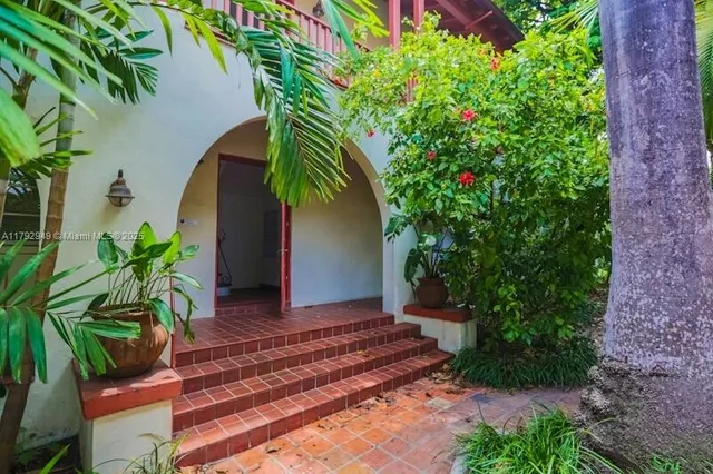 a view of a house with potted plants
