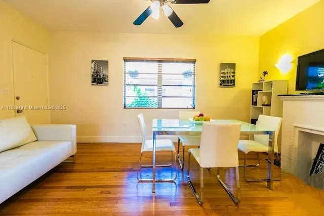 a view of a dining room with furniture and wooden floor