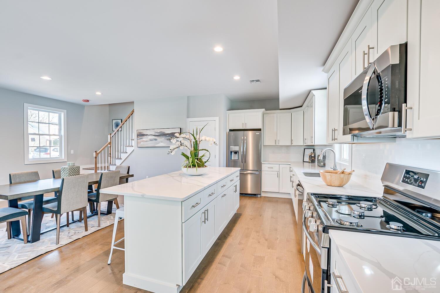 31 Sturgis Road Edison, NJ 08817 - Photo 12 of 35 a large kitchen with stainless steel appliances granite countertop a lot of counter space and wooden floors