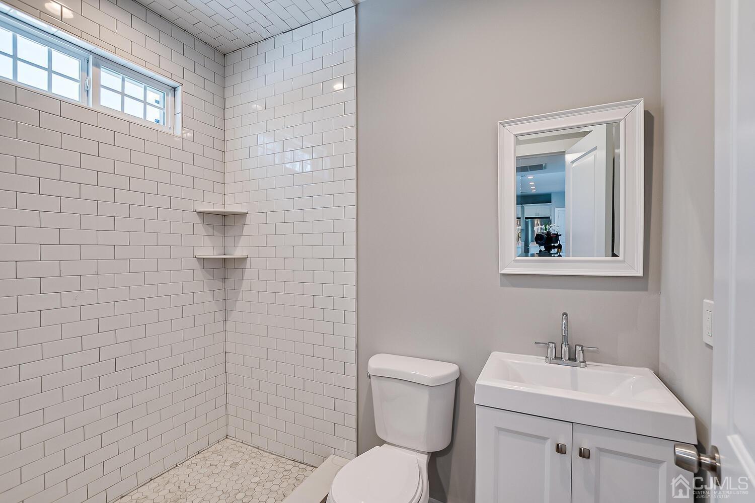 31 Sturgis Road Edison, NJ 08817 - Photo 21 of 35 a bathroom with a toilet sink and mirror