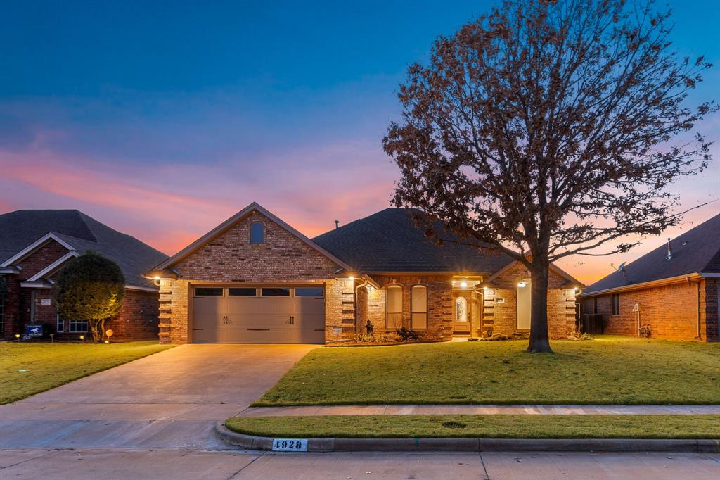 4928 Legacy Drive Wichita Falls, TX 76310 - Photo 1 of 1 View of front of home with driveway, brick siding, a lawn, and an attached garage