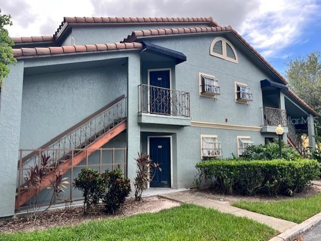 5128 Conroy Road, Unit 22 Orlando, FL 32811 - Photo 2 of 9 a front view of a house with a yard
