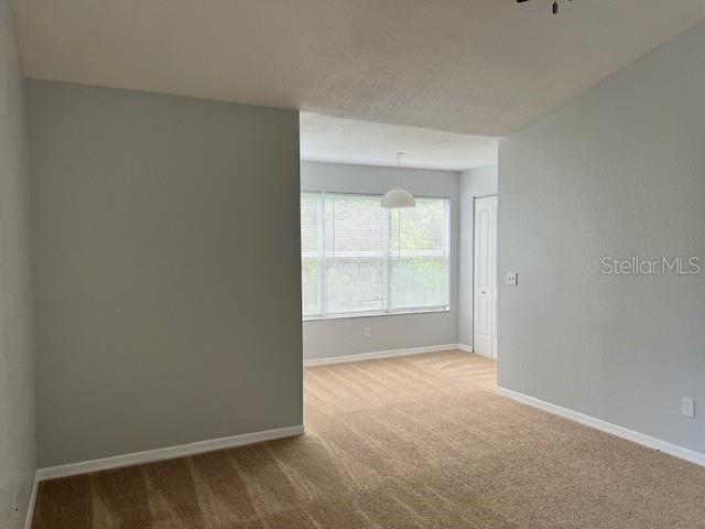 5128 Conroy Road, Unit 22 Orlando, FL 32811 - Photo 3 of 9 a view of an empty room and a window